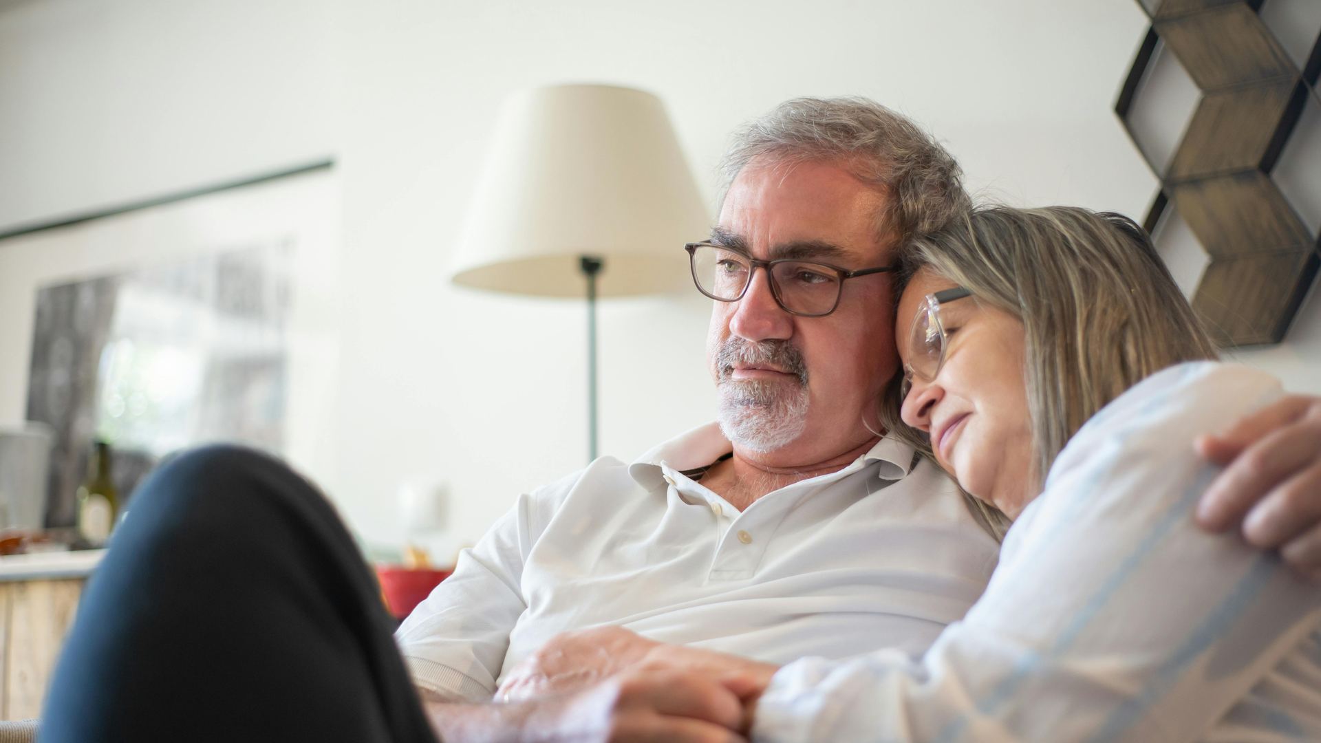 An older couple sitting together at home