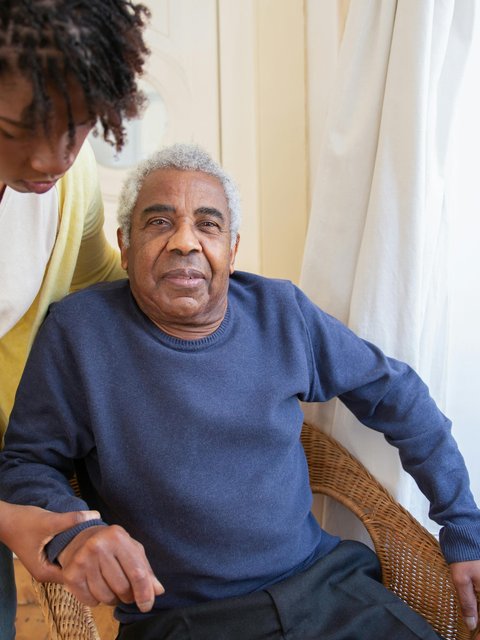 An elderly patient with their caregiver at home
